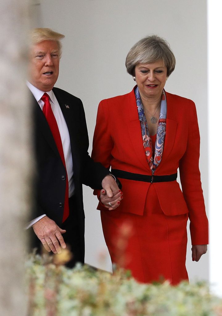 Donald Trump holds Theresa May's hand