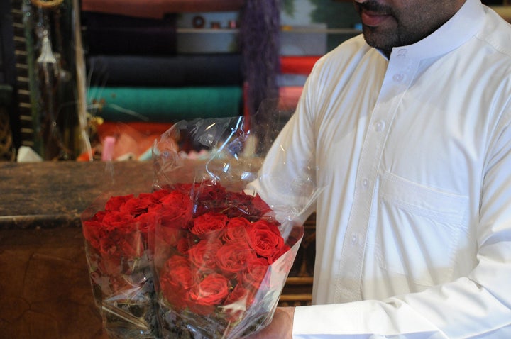 A Saudi man holds bouquets of red roses at a flower shop in the Saudi city of Dammam just before Valentine's Day, on Feb. 13, 2008.