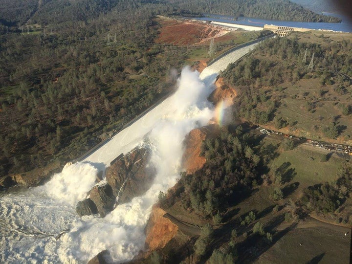 A damaged spillway with eroded hillside is seen in an aerial photo taken over the Oroville Dam in California on Feb. 11.