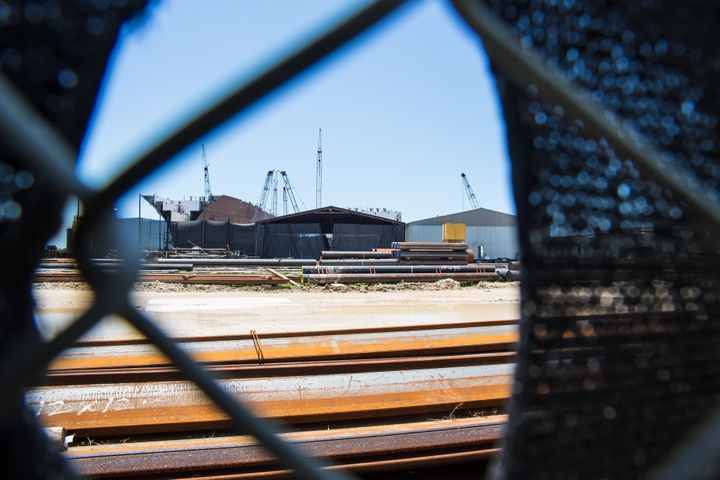 VT Halter Marine’s Pascagoula, Mississippi, shipyard, seen through a hole in fencing fabric.