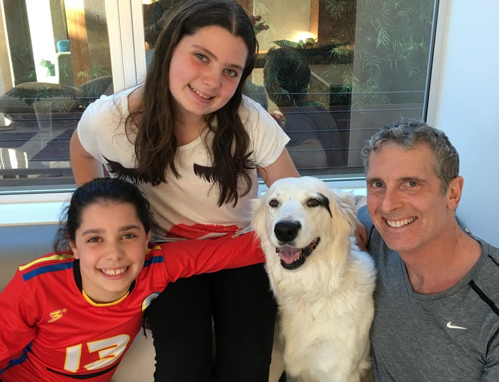 <p>Dr. Brian and his daughters with Roxy who they rescued. </p>