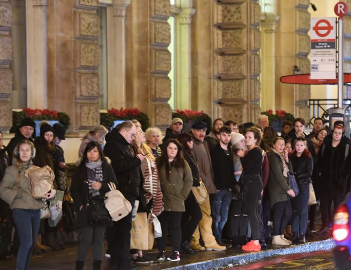 Commuters wait for a bus during strikes earlier this year