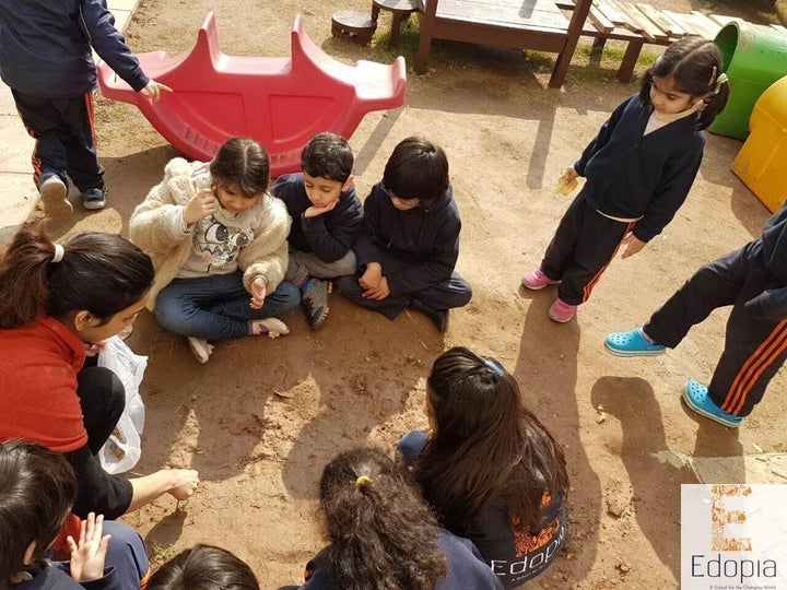 <p>Students at Edopia in a meeting discussing how they would like to create a garden.</p>