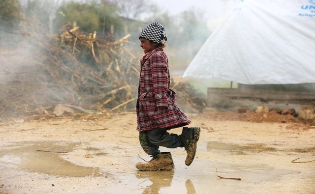 A displaced Syrian girl walks at a refugee camp in the eastern Ghouta region on the outskirts of the capital Damascus on Feb.