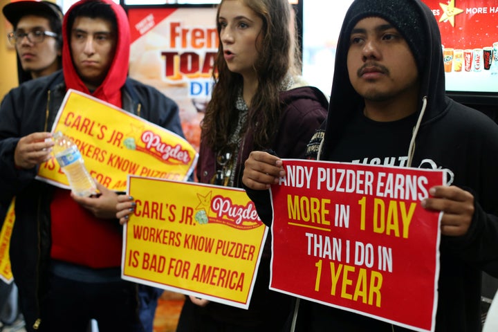 Fast-food workers in Los Angeles take part in nationwide protests to denounce Donald Trump's nomination of Andy Puzder, a restaurant mogul who owns Carl's Jr. and other chains, as labor secretary.