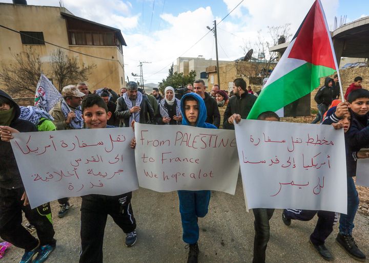 Palestinian children carry placards during a demonstration against proposed plans by President-elect Donald Trump to move the US embassy in Israel to Jerusalem, in the village of Kfar Qaddum, near Nablus, in the occupied West Bank