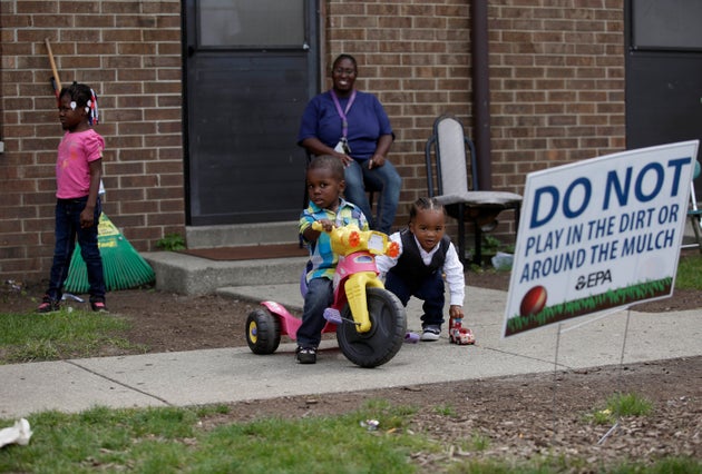 Residents of East Chicago, Indiana, like Nayesa Walker (center top) and her children were asked to leave...