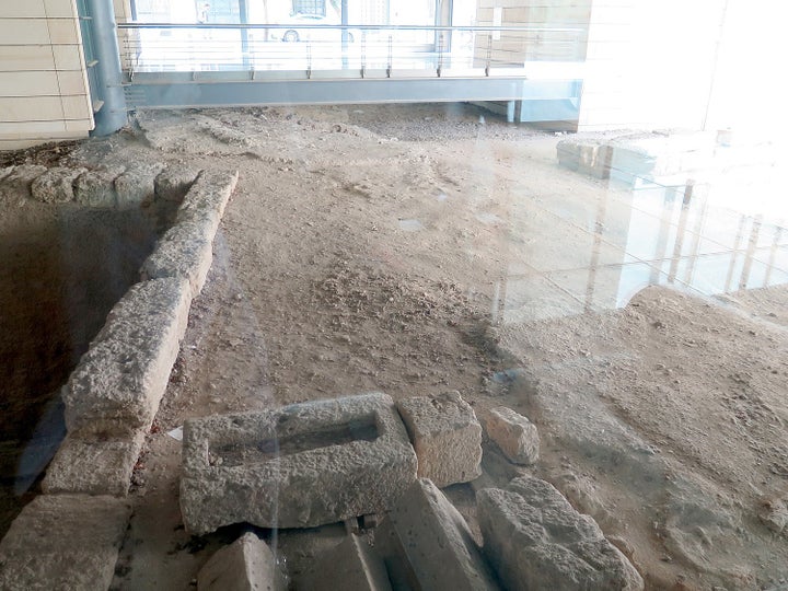 An office building puts glass floor over ruins of an ancient highway, exposed during the construction.