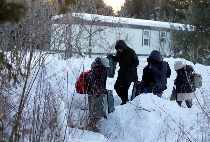 A family from Yemen crosses the U.S.-Canada border into Hemmingford, Quebec, on Feb. 14, 2017.