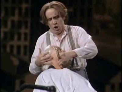 Sweeney Todd (George Hearn) prepares to slit a customer's throat in a scene from <em><strong>Sweeney Todd: The Demon Barber o