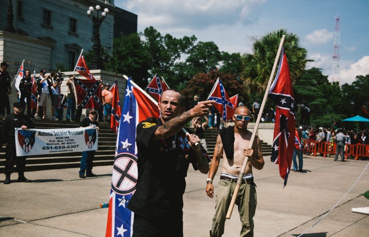 A member of the Ku Klux Klan from Kentucky and a member of the Loyal White Knights branch of the Ku Klux Klan from Pelham, North Carolina rally at the South Carolina State House to protest against the removal of the Confederate Flag from State House grounds on July, 18, 2015.