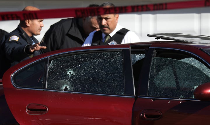 Chicago police stand near where a toddler and a man were fatally shot and a woman was wounded in Chicago's Lawndale neighborhood on Tuesday.