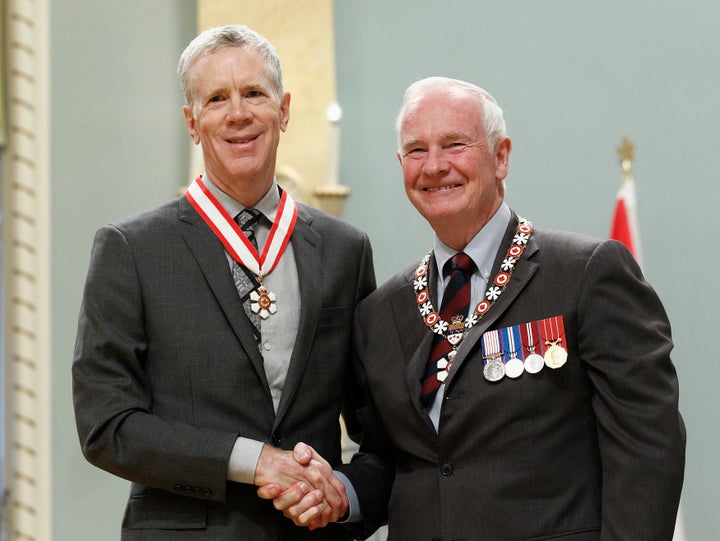 Stuart McLean, left, shakes hands with Governor General David Johnston after being awarded the rank of Officer in the Order of Canada at Rideau Hall in 2012.