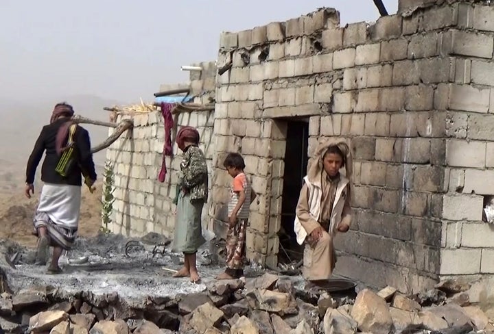 Residents inspect a house that was damaged during the raid.