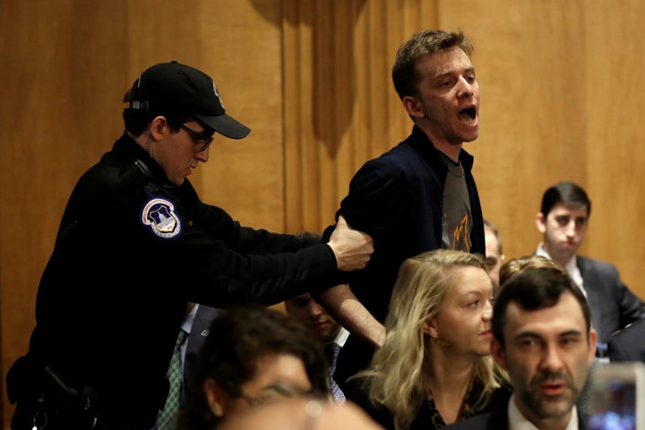 Police remove a protester during the Senate Foreign Relations Committee hearing on David Friedman's nomination. 