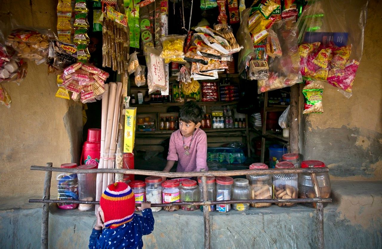A young boy works at a shop in Kutapalong.