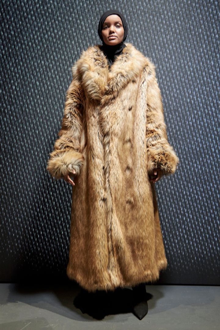Model Halima Aden in a long fur coat at Yeezy. 