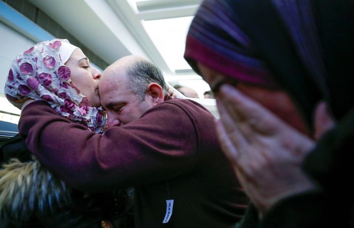 Syrian refugee Baraa Haj Khalaf kisses her father Khaled as her mother Fattoum cries after arriving at O'Hare Airport in Chicago on Feb. 7, 2017.