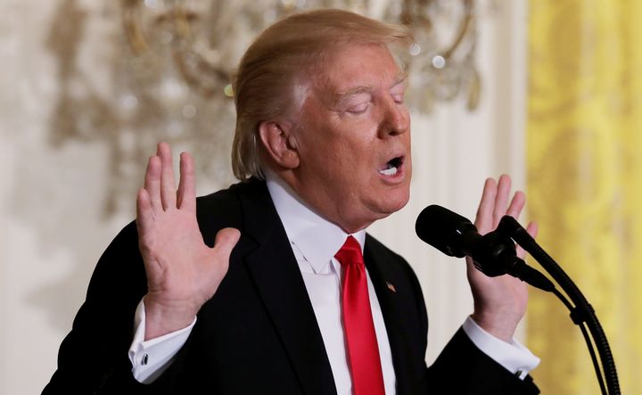 Trump reacts to a question from reporters during a lengthy news conference at the White House.