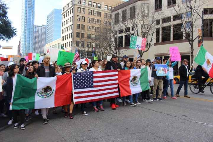 Protesters march down Congress Ave in downtown Austin on Feb. 16, 2017, toward the Texas state legislature in support of immigrant rights following a series of hundreds of arrests by Immigration and Customs Enforcement. The march was one of many across the country billed as "Day Without Immigrants," in protest of President Donald Trump's crackdown.