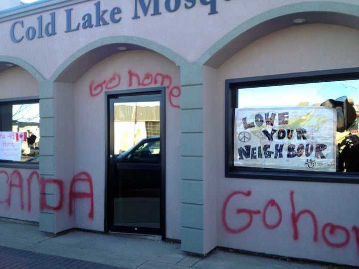 Graffiti reading "<a href="http://www.huffingtonpost.ca/2014/10/24/cold-lake-mosque_n_6043086.html" target="_blank" role="link" class=" js-entry-link cet-internal-link" data-vars-item-name="Go home" data-vars-item-type="text" data-vars-unit-name="58a70ecbe4b07602ad53e40d" data-vars-unit-type="buzz_body" data-vars-target-content-id="http://www.huffingtonpost.ca/2014/10/24/cold-lake-mosque_n_6043086.html" data-vars-target-content-type="feed" data-vars-type="web_internal_link" data-vars-subunit-name="article_body" data-vars-subunit-type="component" data-vars-position-in-subunit="7">Go home</a>" covers a mosque in Alberta on Oct. 24, 2014.