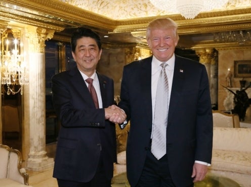 Prime Minister of Japan Shinzō Abe shakes hands with Donald Trump.