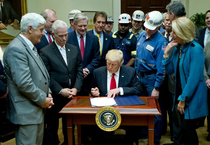 President Donald Trump dismantles the Department of the Interior's Stream Protection Rule, meant to protect waterways from from coal mining operations, at the White House on Feb. 16, 2017.