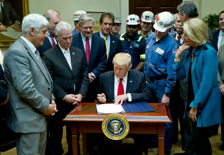 President Donald Trump dismantles the Department of the Interior's Stream Protection Rule, meant to protect waterways from from coal mining operations, at the White House on Feb. 16, 2017.