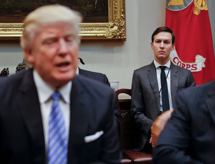 Kushner listens as Trump speaks during a breakfast with business leaders in the Roosevelt Room of the White House.