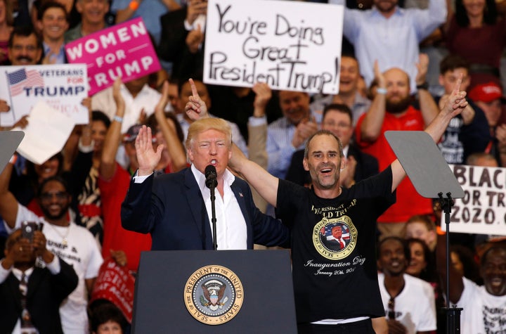 President Donald Trump stands next to Gene Huber, a supporter he invited onstage at a rally in Melbourne, Florida, on Feb. 18, 2017.