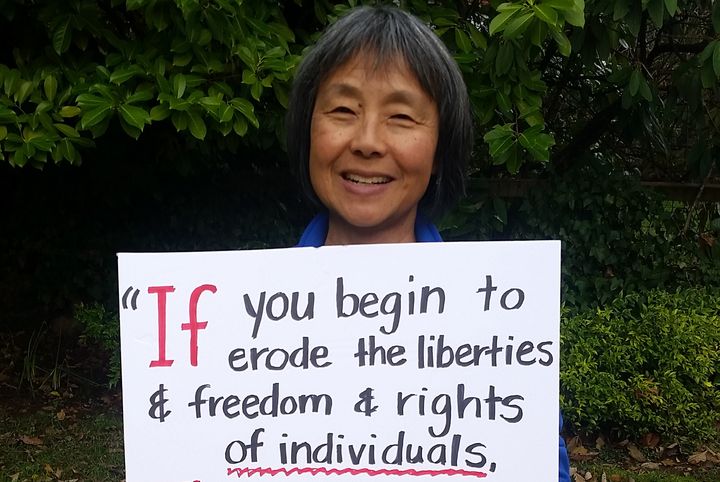 Barbara Yasui holds a sign featuring a quote from her uncle, civil liberties activist Minoru Yasui, on Jan. 21, 2017. The entire quote reads: “If you begin to erode the liberties & freedom & rights of individuals, then you are indeed jeopardizing the safety of our whole nation.”
