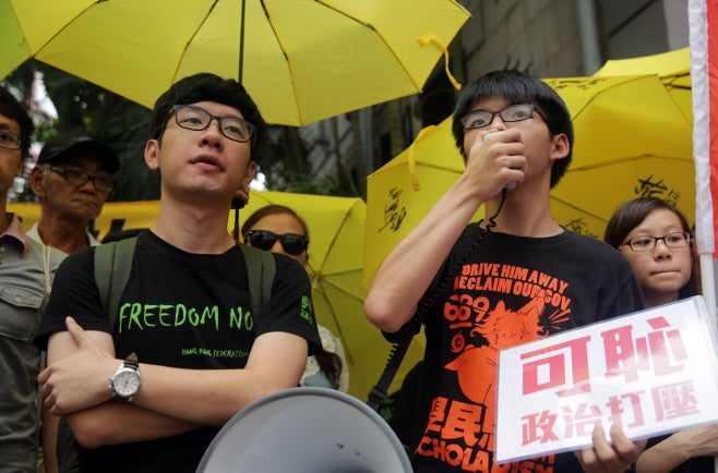 Nathan Law (left) and Joshua Wong on July 14, 2015./ Source: AFP, Yonhap News