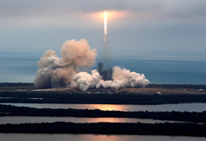 A SpaceX Falcon 9 rocket disappears into clouds after it lifted off on a supply mission to the International Space Station fr