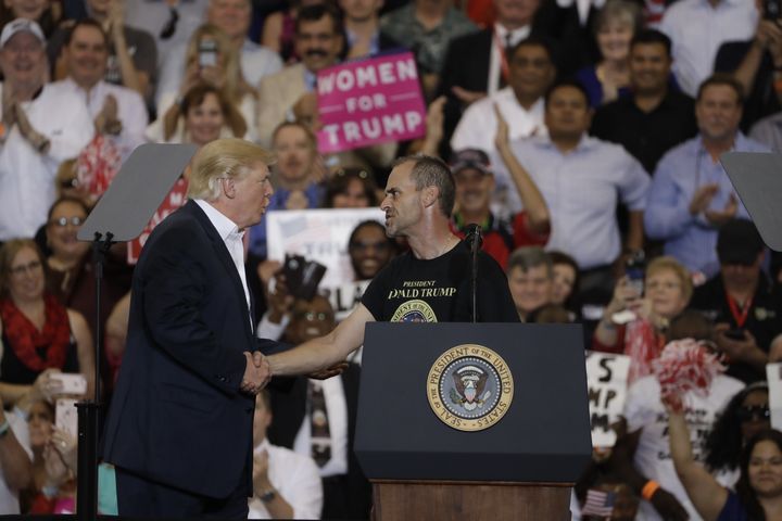 Trump with supporter Gene Huber during the campaign rally on Saturday.