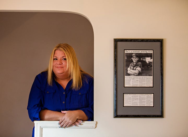 Rosie Palfy stands in an alcove in her old home next to a framed article from the Plain Dealer (Cleveland) in 1993 about her time in the Marine Corps. “She’s a woman among men,” reads the headline about Palfy, who served during the Gulf War. Today, she’s an MST survivor, a homelessness advocate, and almost nine years after first filing her disability compensation claim with VA, she owns her own home. Photo by Scott Shaw.