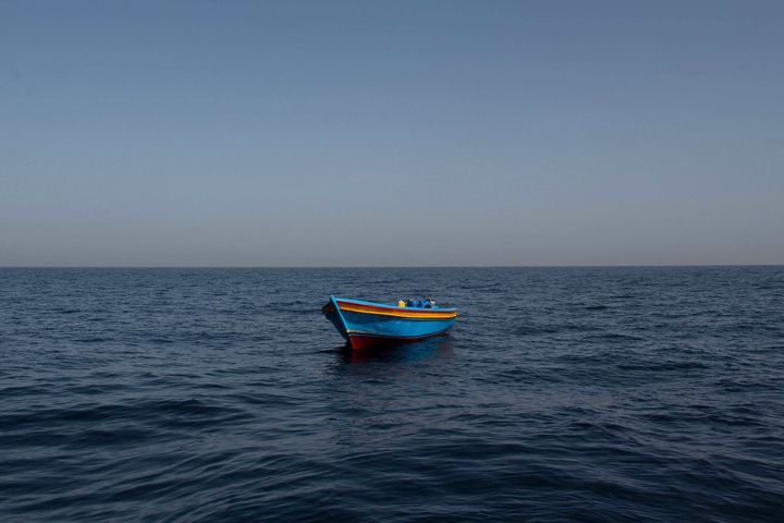 An empty wooden boat is left behind near Libya.