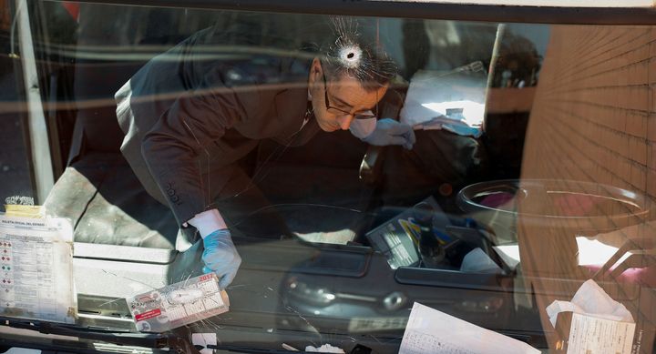 An investigator inside a gas cylinder delivery truck with bullet holes in the windscreen after police fired shots to stop the driver in Barcelona