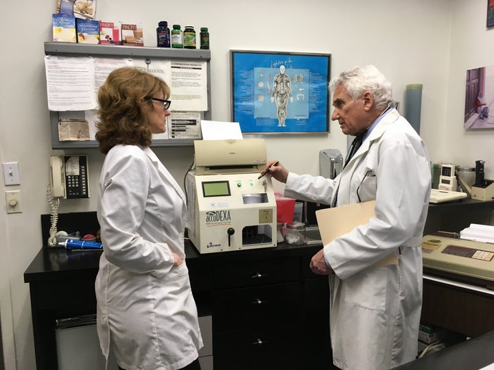 Dr. Howard Shapiro discusses a patient’s progress with assistant Alexandra Lotito at his midtown Manhattan office. Shapiro says marijuana shows promise as an alternative to opioid painkillers and other prescription drugs in treating a wide range of conditions.