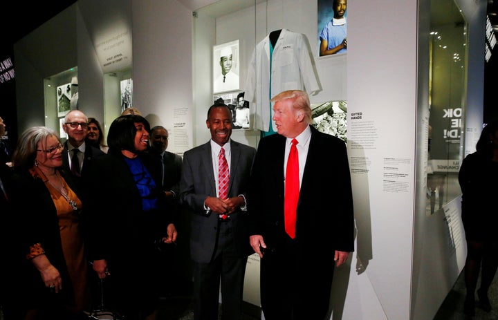 President Donald Trump stands with his nominee to lead the Department of Housing and Urban Development, Dr. Ben Carson, on Tuesday while visiting the Carson exhibit at the National Museum of African American History and Culture in Washington, D.C.