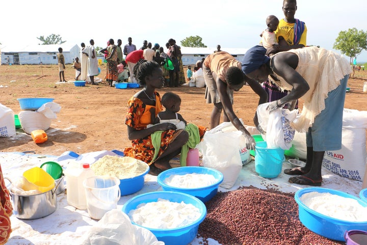 <p>Victims fleeing South Sudan’s war receiving food aid from WFP and the U.S. Food for Peace program. Tragically, there have been ration cuts to refugees because of low funding. </p>