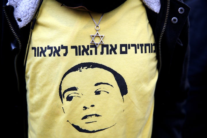 A supporter of Elor Azaria wears a shirt with the words in Hebrew "Bringing the light back to Elor" during a protest outside the military court in Tel Aviv.