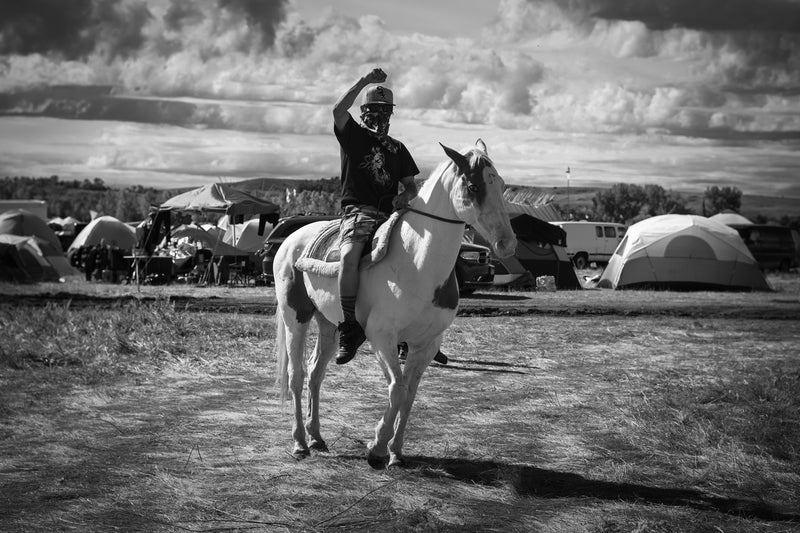 MJ, a young water protector patrolling the camp for security with his horse Champagne. The Standing Rock Sioux tribe has oppo
