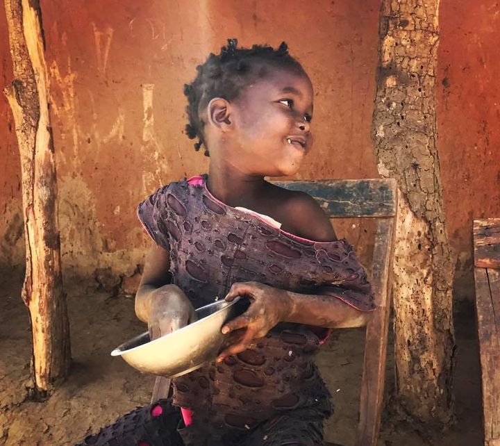 What does this photo of a girl eating rice have to do with economic empowerment?
