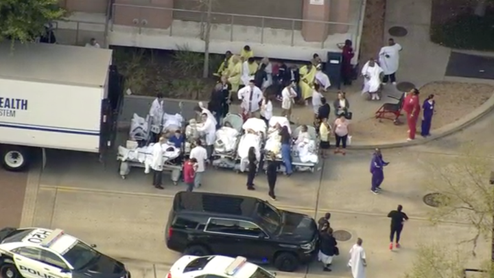 Patients are seen being lined up outside the hospital after reports of a shooting.