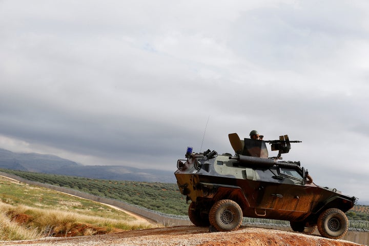 A Turkish soldier on an armored military vehicle patrols the border between Turkey and Syria, Nov. 1, 2016.