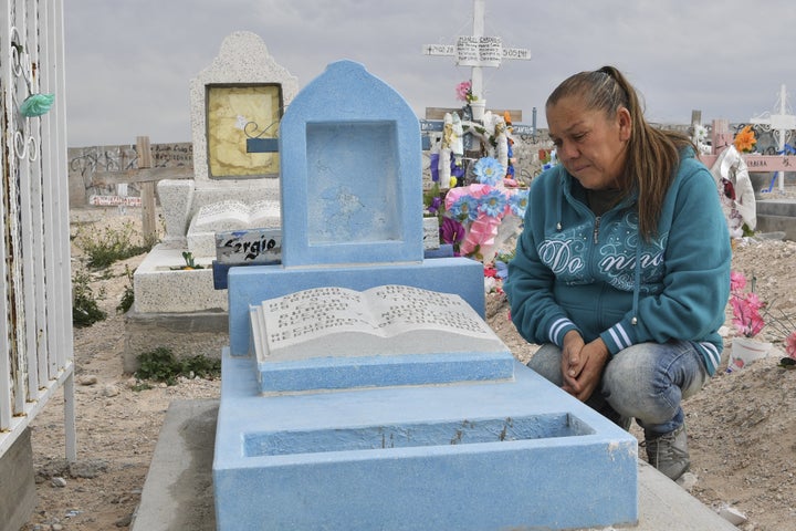 Maria Guadalupe Guereca, 60, visits the grave of her son Sergio Hernandez at the Jardines del Recuerdo cemetery in Ciudad Ju&