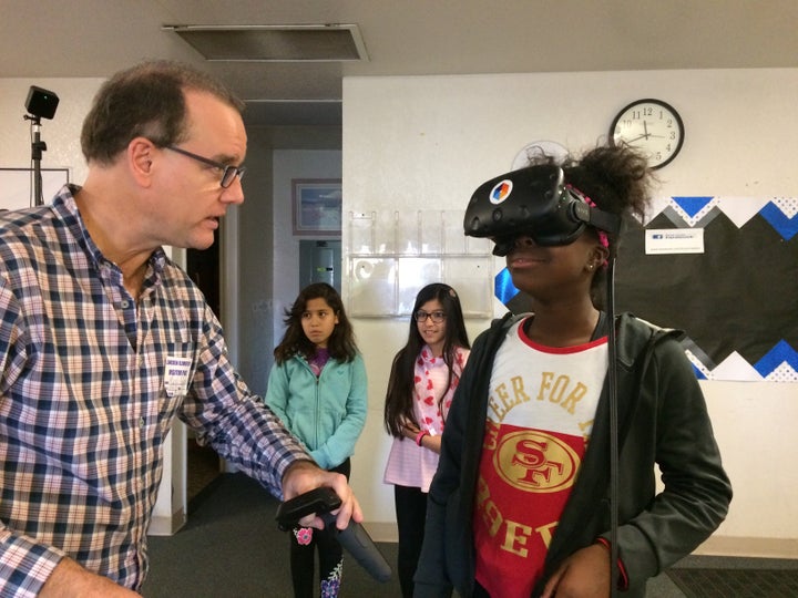 Jada Ikharo, a 5th grader at Lincoln Elementary in Manteca, gets a virtual reality lesson from Mark Andersen, co-founder of Lifeliqe.