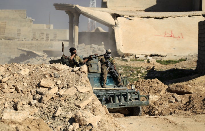 Iraqi security forces' members are pictured in the liberated part of Albu Saif village south of Mosul, Iraq February 21.