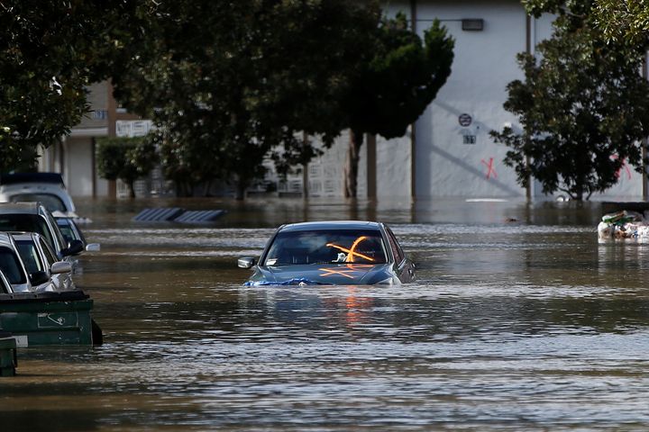A vehicle is seen partially submerged in floodwater after heavy rains overflowed nearby Coyote Creek in San Jose.