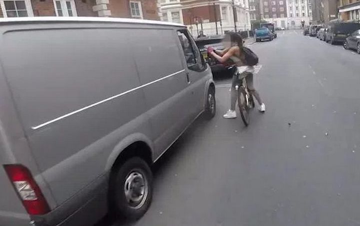The video shows a female cyclist ripping the wing mirror off a van